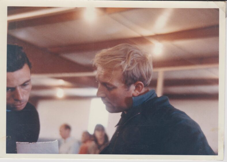 Derek Wild on the right in discussion with racing legend Jim Clark.