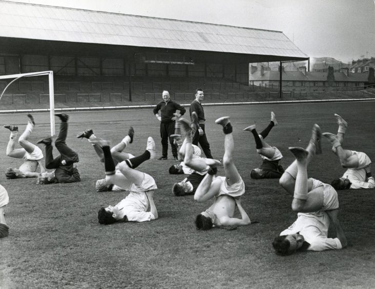 Dundee FC players doing exercises during training session at Dens Park. 