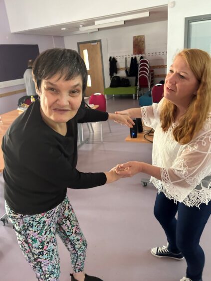 Person dancing with carer.