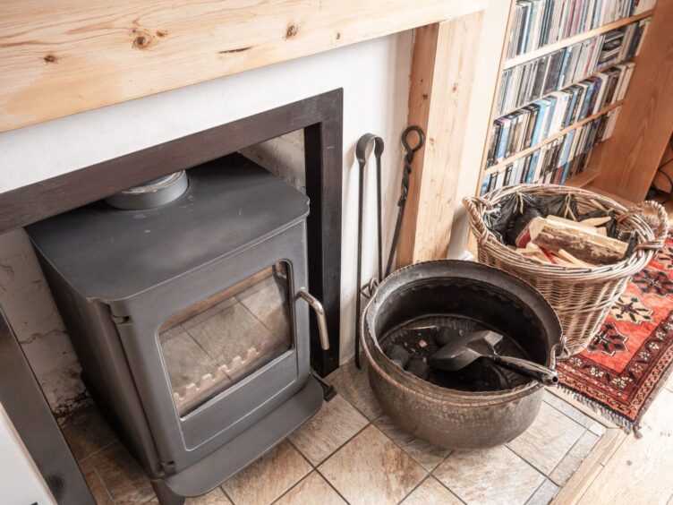 A log burner sits at the heart of the living room.