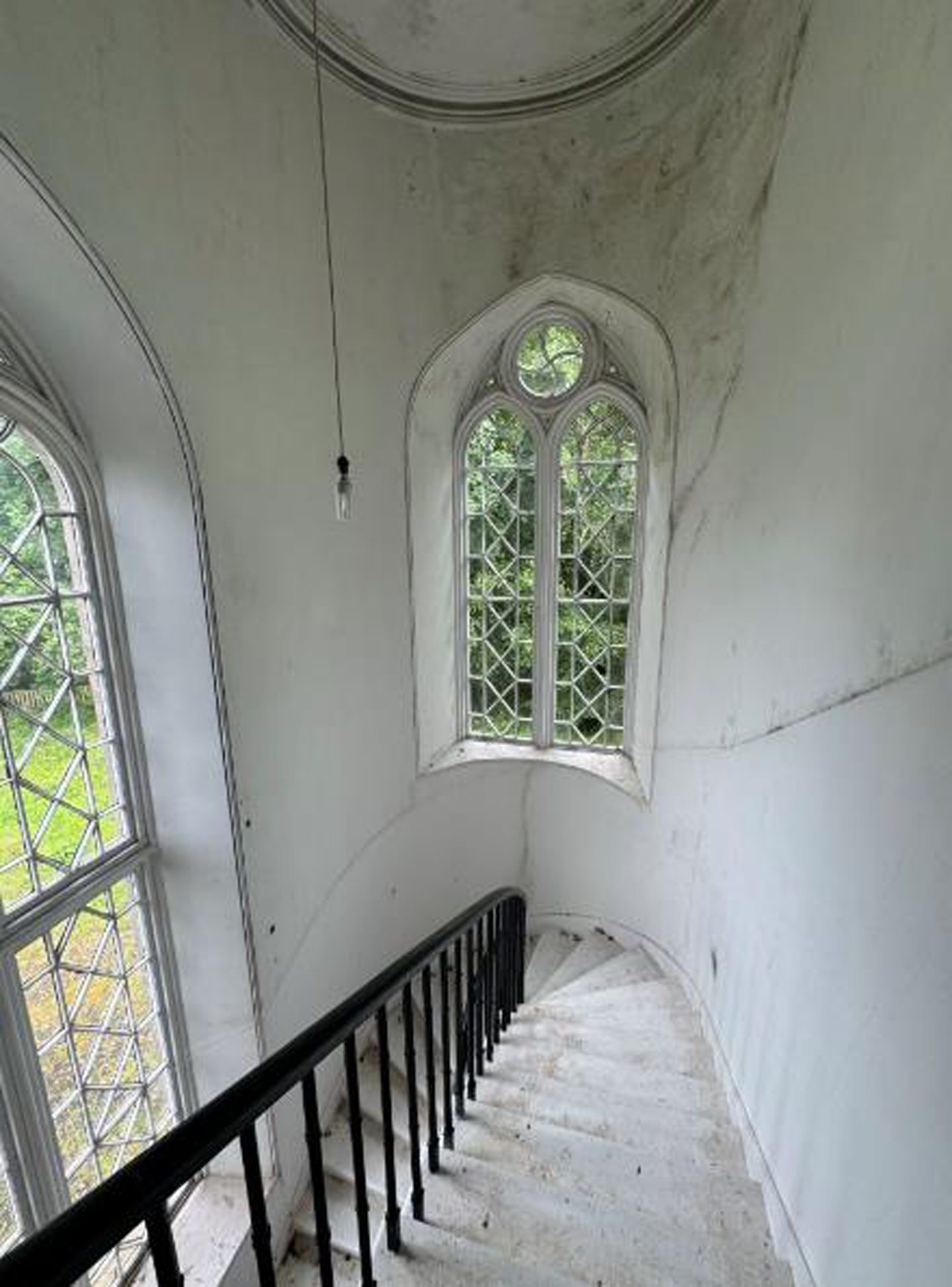 An interior staircase and windows. 