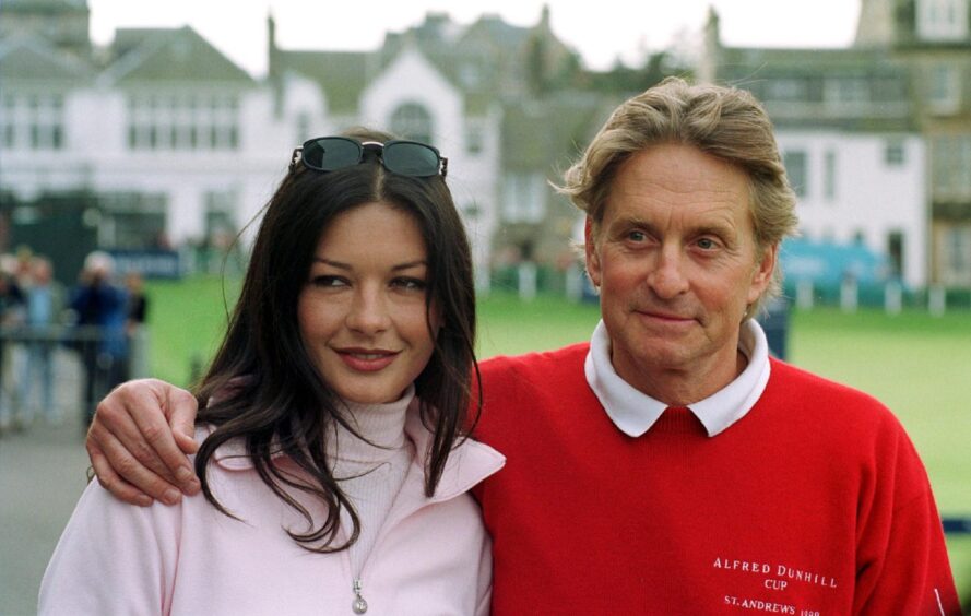Catherine Zeta-Jones and Michael Douglas relax at the Old Course in 1999.