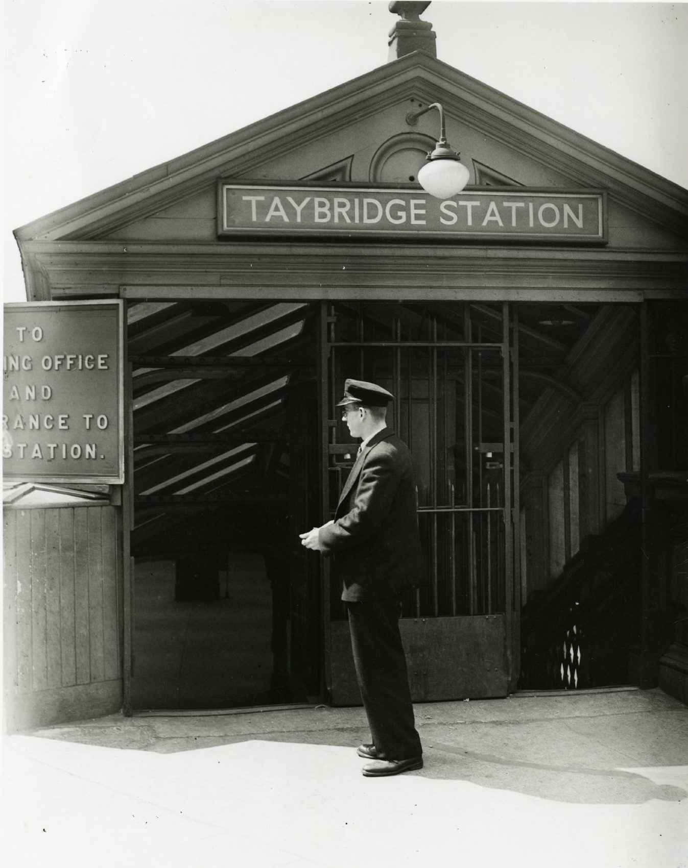 A railway employee at the Tay Bridge Station entrance in the early 20th Century.