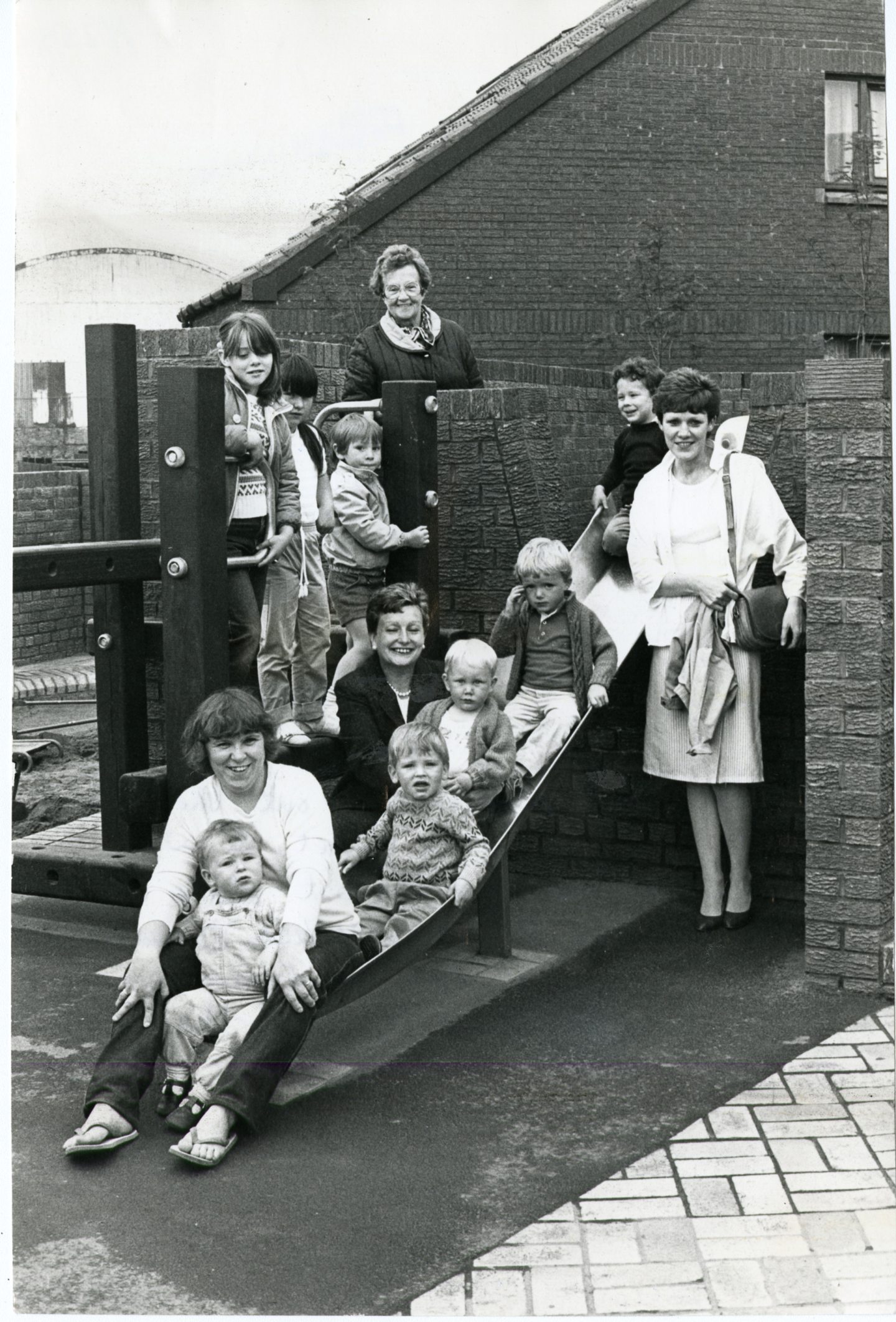 Parents and children smile for the camera at Stirling Street playpark in 1985.