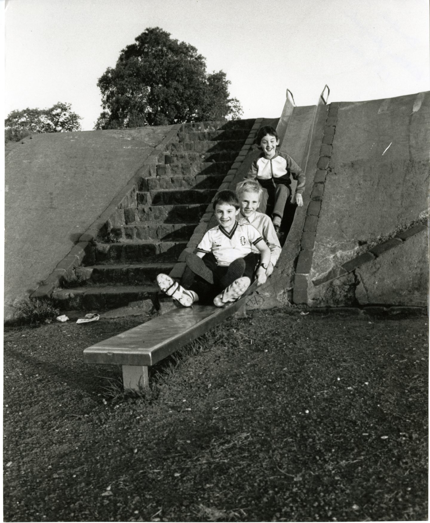 Children playing on the chute in Kirkton. 