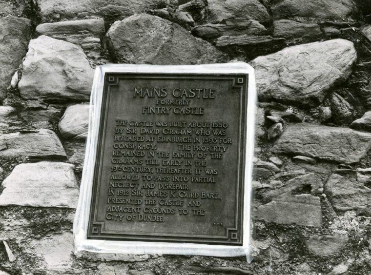 The plaque on the wall outlining the history of Mains Castle 