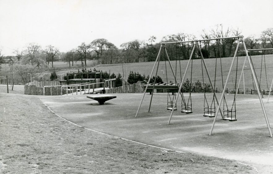 The new Mill O'Mains playpark in 1980 with grass and trees in the distance