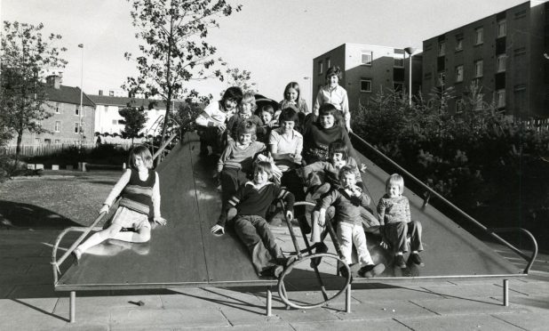 Children on the chute in the playground of the Lochee multis in 1975.