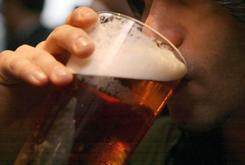 Man drinking a pint of beer