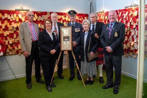 Jack Sim, Angus Lord Lieutenant Pat Sawers, Andrew Sim, Group Captain Andy Tait, Marlene Sim, Robbie Sim and Stuart Archibald of Montrose Air Station Heritage Centre at the unveiling. Image: Kim Cessford/DC Thomson