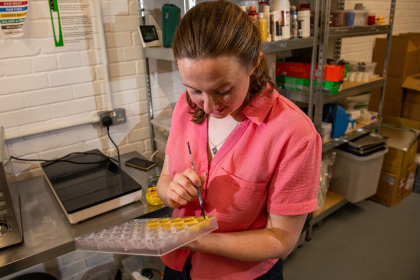 Iona Brownhill prepares the hand-painted chocolate moulds.