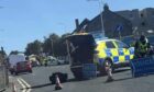 Police close St Clair Street in Kirkcaldy after car flips onto roof in crash.