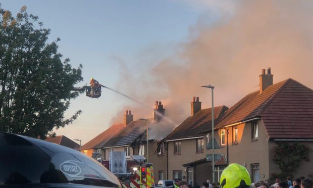 Firefighters at the scene of a house fire in Dundee