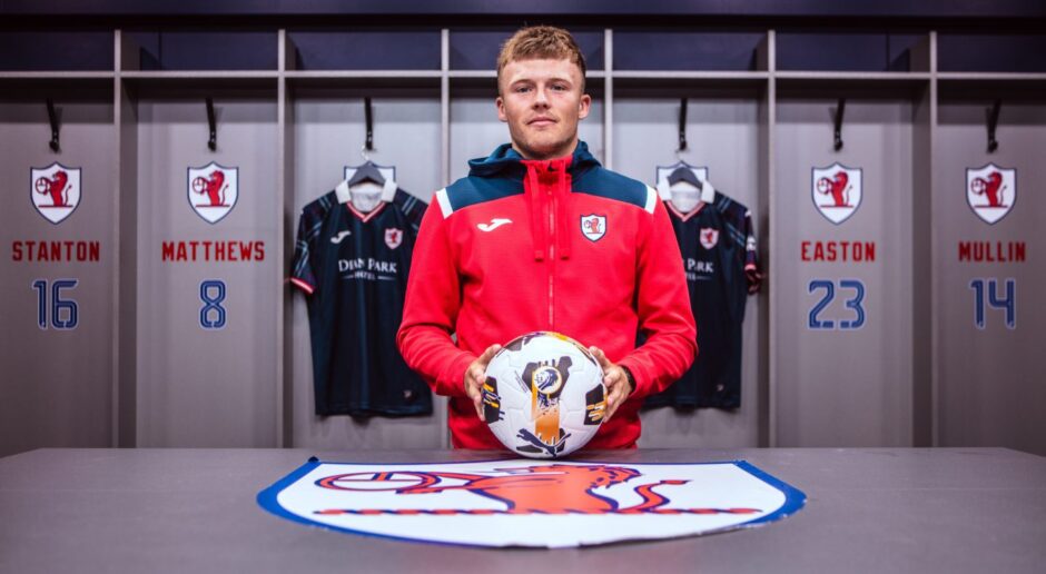 New Raith Rovers signing Lewis Gibson holds a ball inside the Stark's Park dressing room.