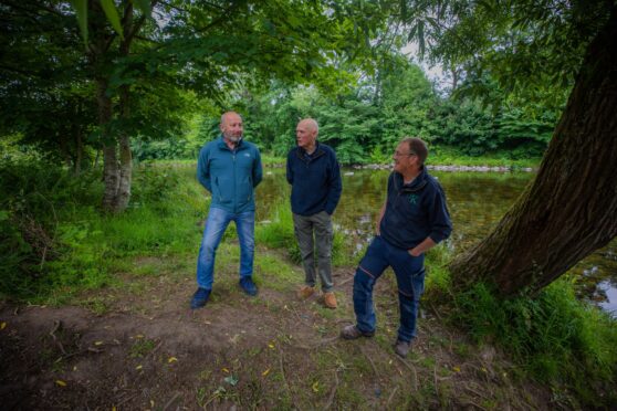 Peter Lock , David Hogg and Robert Kellie standing on river bank at Blairgowrie