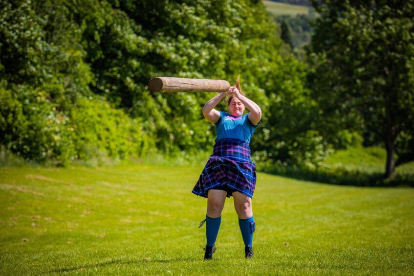 Highland Games competitor shows Laura Barber tosses the caber at Pitlochry Recreation Park. Image: Steve MacDougall.