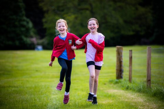 Glamis Primary pals Poppy Low (left) and Ellie Breckenridge enjoy the Glamis games. Image: Steve MacDougall/DC Thomson