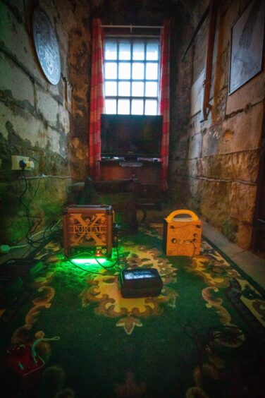 Image shows: some of the equipment used by Scottish Paranormal to communicate with ghosts or spirits at Balgone Castle. Three gadgets are shown sitting on the floor of the Laird's Room with a Frank's Box top right.
