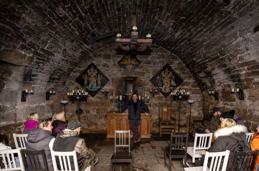 Image shows Gregor of Scottish Paranormal talking to visitors about the history and stories behind the chapel.
