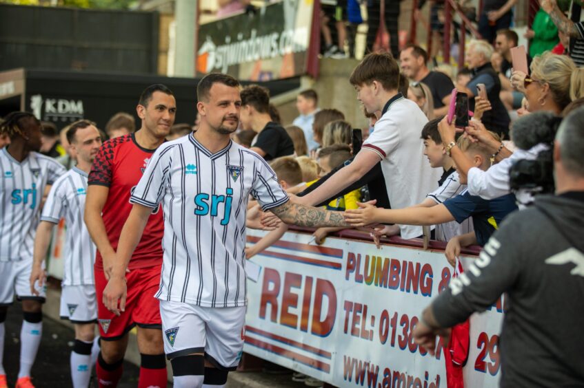 Captain Kyle Benedictus leads out the Pars squad for the new kit launch.