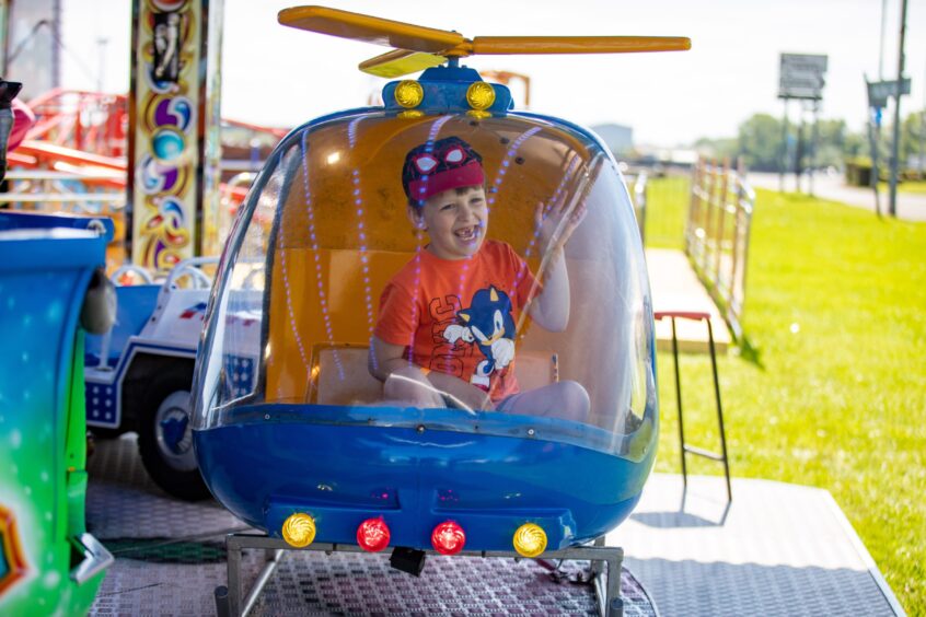 Lennin Tasker, 5, from Crail, flies a helicopter at the Leven funfair