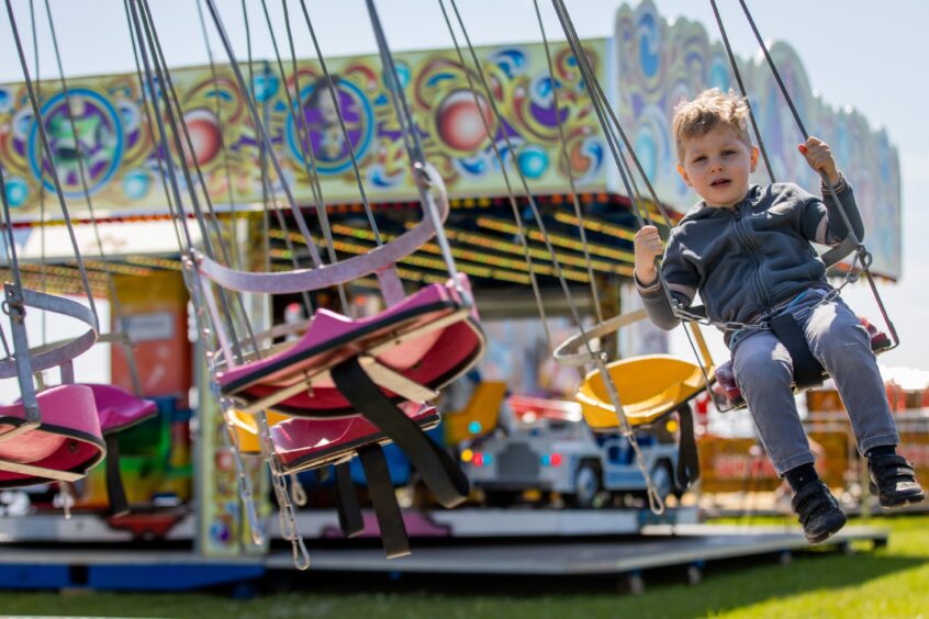 Oliver, 3, from Glenrothes on the chairoplanes at the Leven funfair