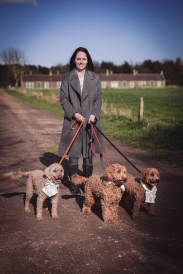 Solo Paws director Laura Findlay with three labradoodles, Wilf, Louis and Honey, that she chaperoned at David and Carolanne Heighton's wedding at the Rhynd near Leuchars in Fife. Supplied.