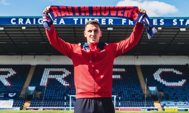 New Raith Rovers signing Paul Hanlon holds up a scarf.