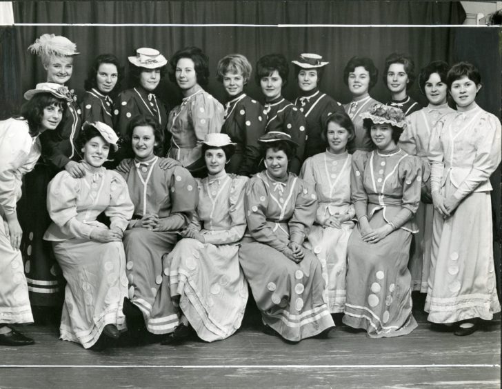 The female cast members of Oklahoma! pose for a picture on stage