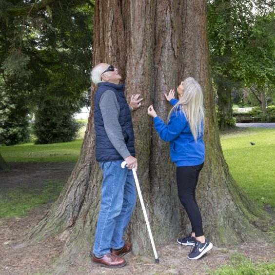 Visually impaired Ian Todd (left) and Seescape health and wellbeing co-ordinator Wendy Leary stop to enjoy the trees in Pittencrieff Park, Dunfermline.