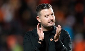 Tam Courts applauds Dundee United fans during his time in charge