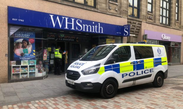 Police entering WH Smith at the Murraygate. Image: James Simpson/DC Thomson