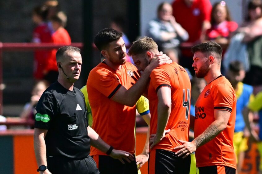 Kevin Holt, visibly worse for wear, is withdrawn for Dundee United