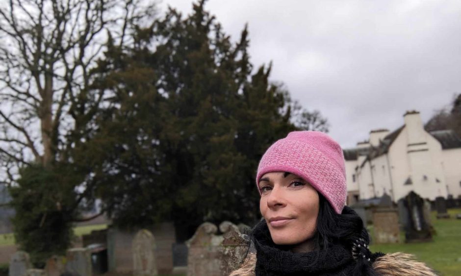 Gayle checks out the Fortingall Yew - and hopes it survives for many years. Image: Gayle Ritchie.