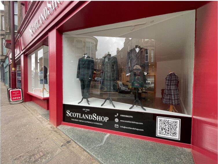 House of Tartan exterior with red paintwork and tartan outfits in window