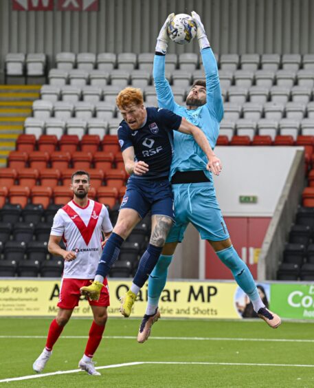 Josh Rae collects a cross under pressure from Ross County striker, Simon Murray. 