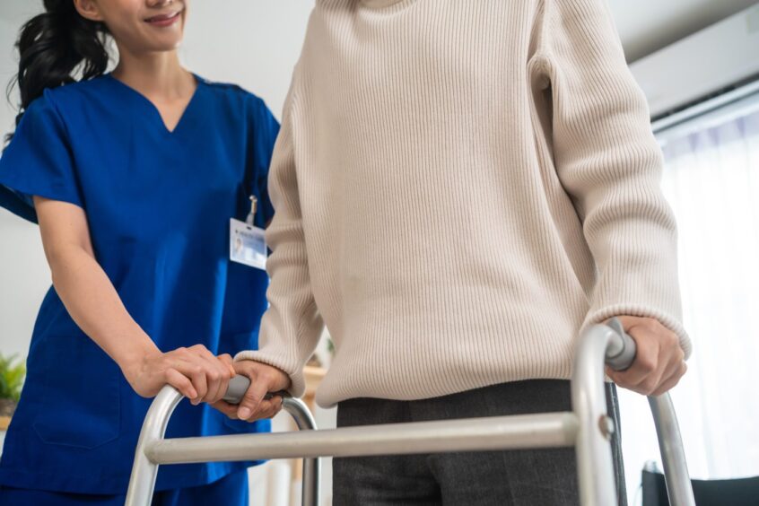 Asian senior elderly man patient doing physical therapy with caregiver