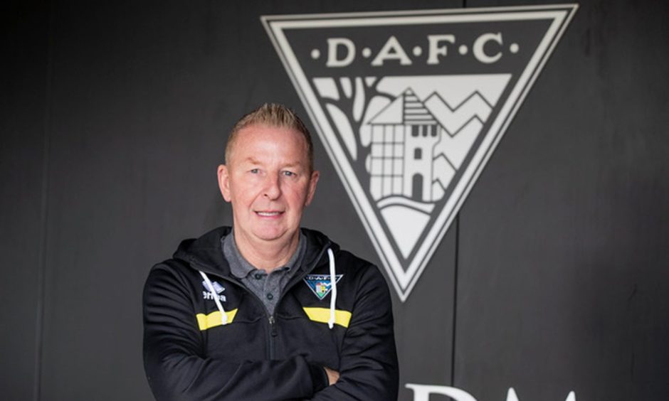 John McLaughlan pictured in front of a large Dunfermline Athletic badge.