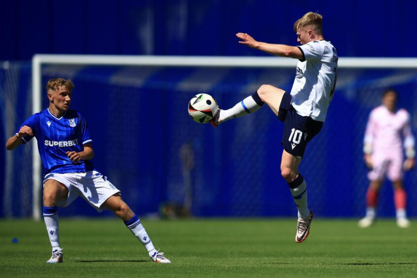 Dundee skipper Luke McCowan takes the game to Lech Poznan. Image: David Young