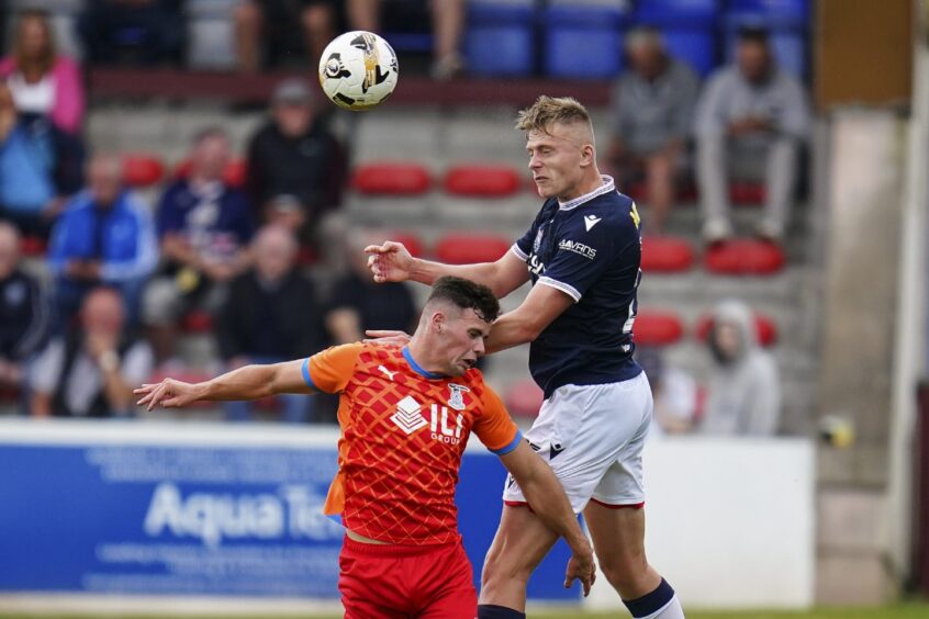 Luke Graham wins an aerial battle against Inverness on his full debut. Image: David Young/Shutterstock