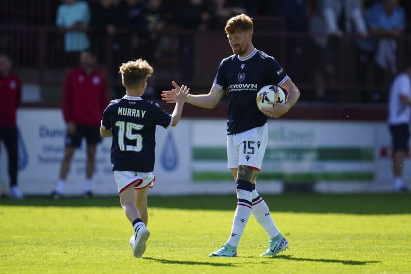 Simon Murray takes the acclaim of a young Dundee fan as he grabs the matchball. Image: Pete Summers/Shutterstock