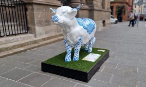 Blue and white Highland cow sculpture outside Perth Museum