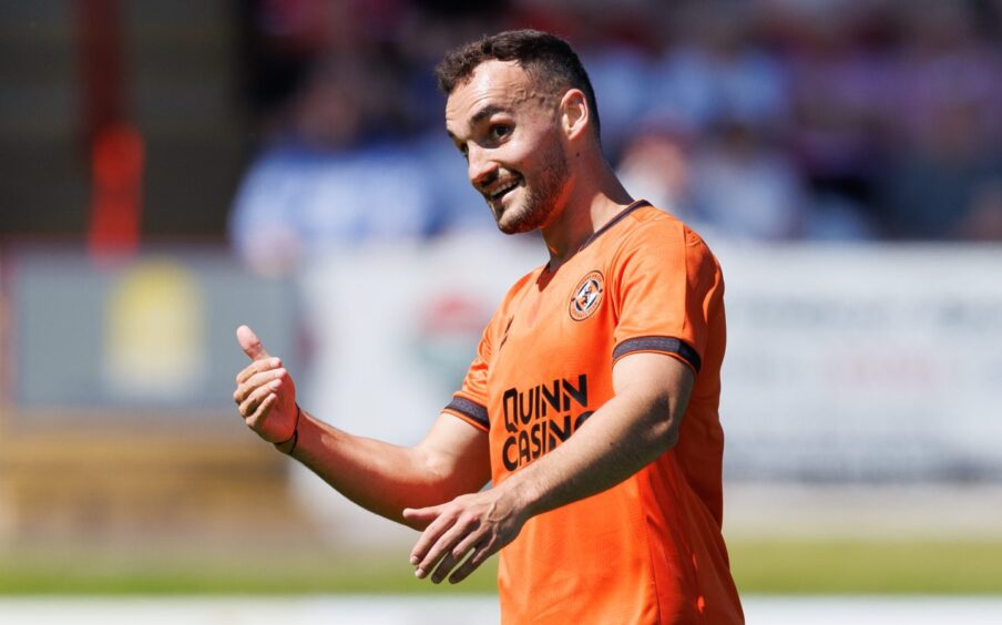 Vicko Sevelj dishes out instructions to his Dundee United teammate