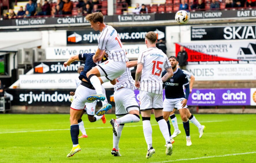 Curtis Main heads in Dundee's second goal against the Pars in a crowded box.