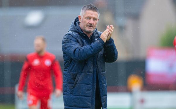 Dundee boss Tony Docherty salutes the travelling fans after racking up a 7-1 win. Image: SNS