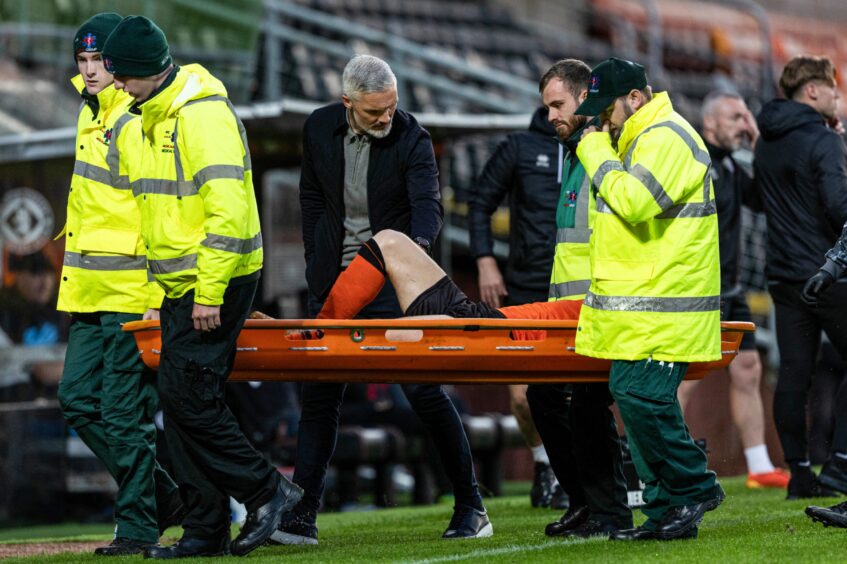 Ryan Strain of Dundee United leaves the field on a stretcher