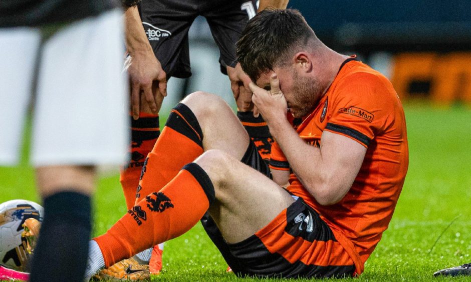 A distraught Ryan Strain on the Tannadice turf.