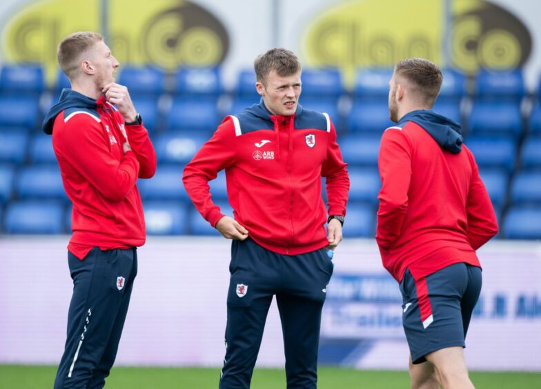 Lewis Gibson chats with Raith Rovers team-mates Liam Dick and Callum Smith.