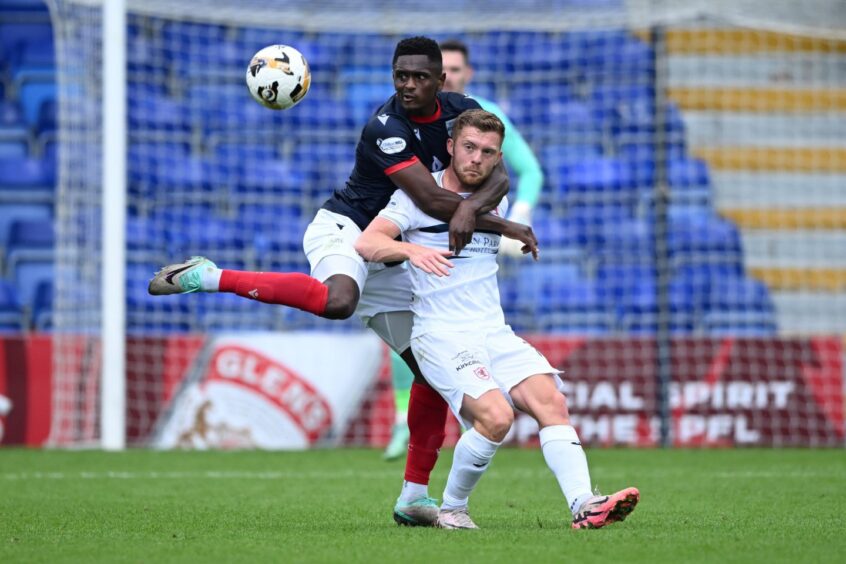 Callum Smith is well shackled in Raith Rovers' cup tie against Ross County.