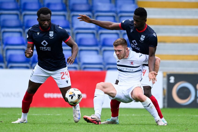 Raith Rovers striker Callum Smith battles for possession against Ross County. 